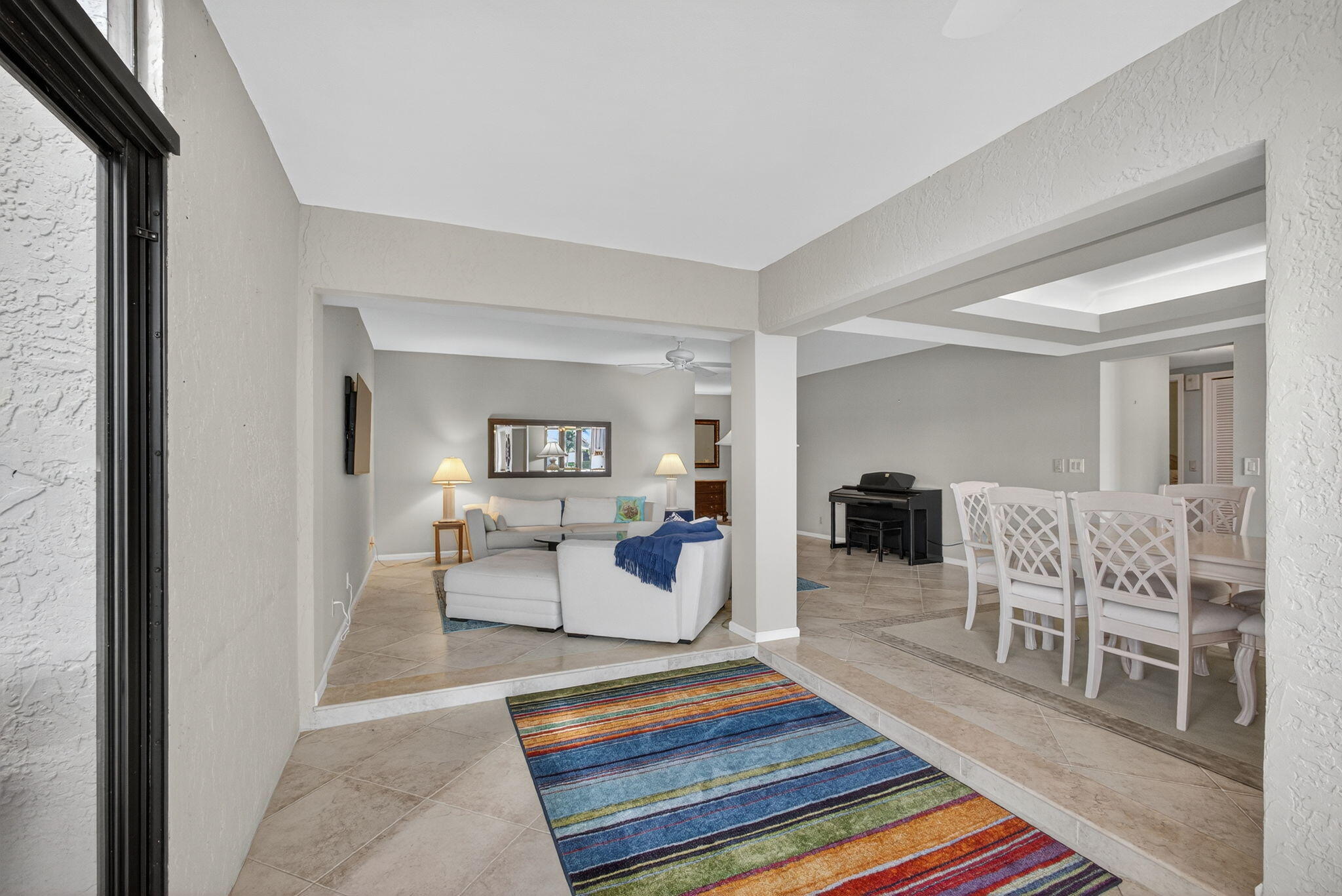 16885 Waterbend Drive, Unit 175 Jupiter, FL 33477 - Photo 21 of 43 a living room with furniture a rug and kitchen view