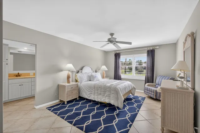 a bedroom with a bed a dresser and window