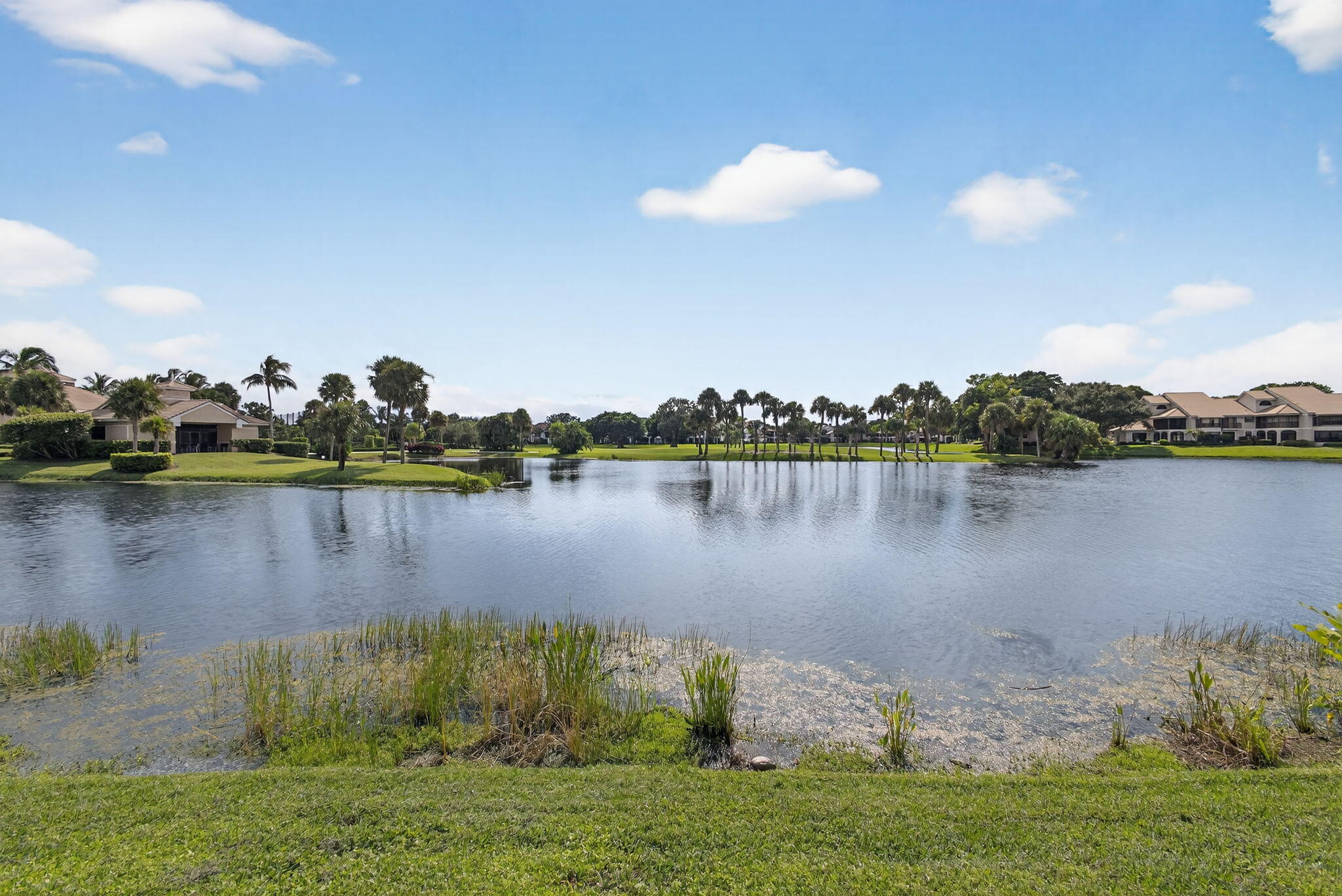 16885 Waterbend Drive, Unit 175 Jupiter, FL 33477 - Photo 31 of 43 a view of a lake with a big yard