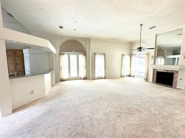 a large kitchen with window and a fireplace