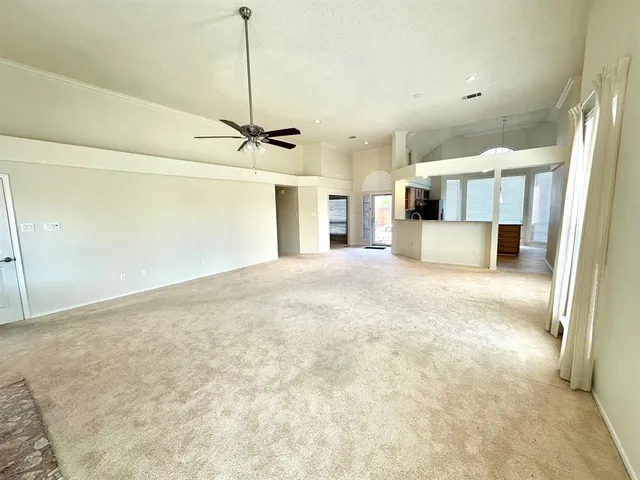 a view of a kitchen with a sink and a refrigerator