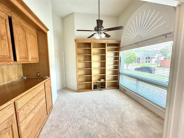 a spacious bedroom with a bed and a chandelier