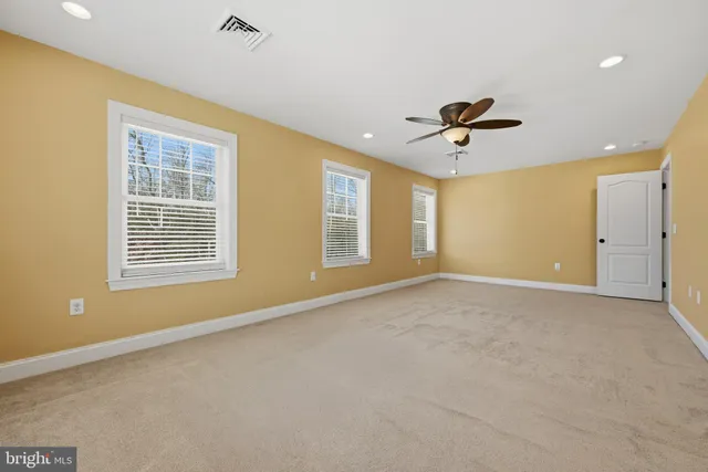 a view of a house with a yard covered with snow