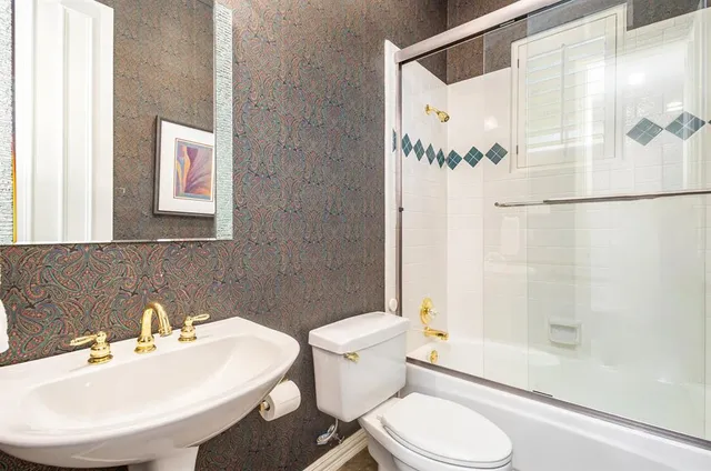 a bathroom with a sink toilet and shower