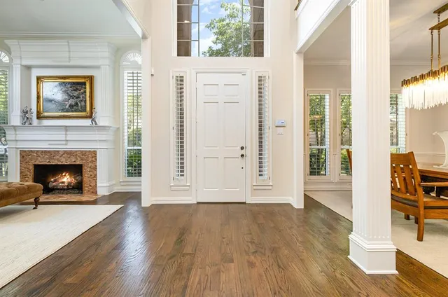 a view of a livingroom with wooden floor and a fireplace
