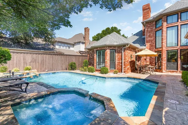 a view of a house with backyard outdoor seating area and furniture