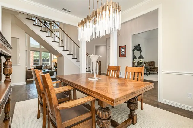 a dining room with furniture and wooden floor