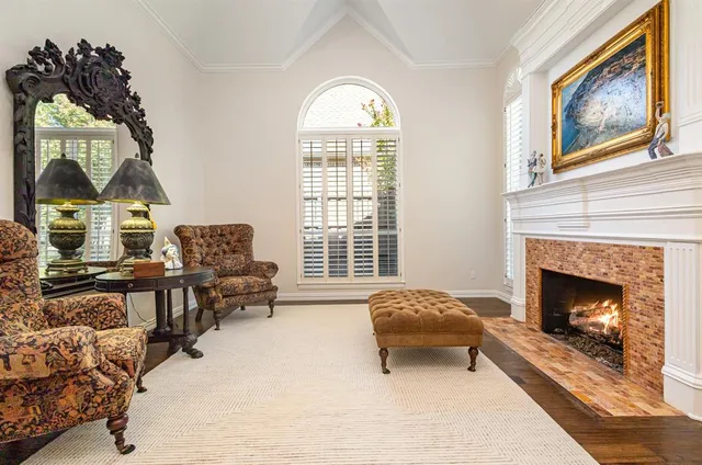 a living room with furniture a window and a fireplace