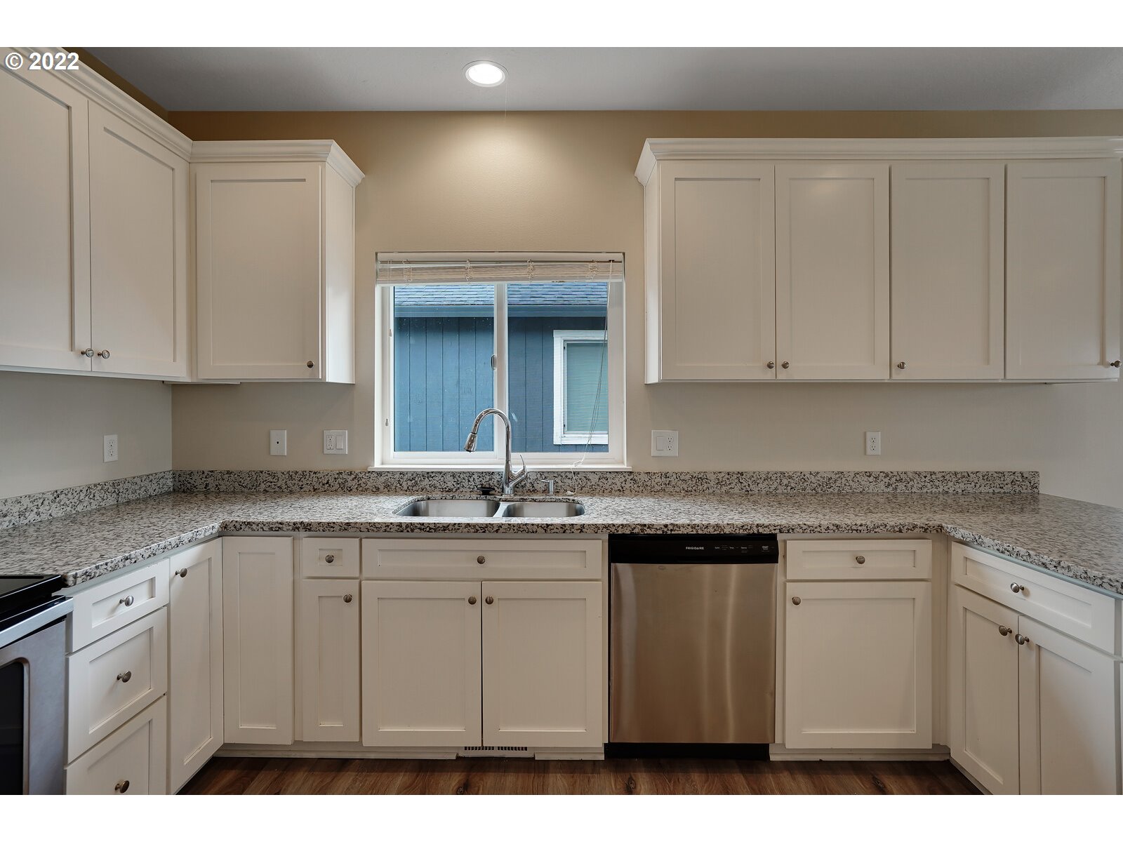 542 East Elm Loop Gervais, OR 97026 - Photo 17 of 32 a kitchen with stainless steel appliances granite countertop a sink and dishwasher with white cabinets