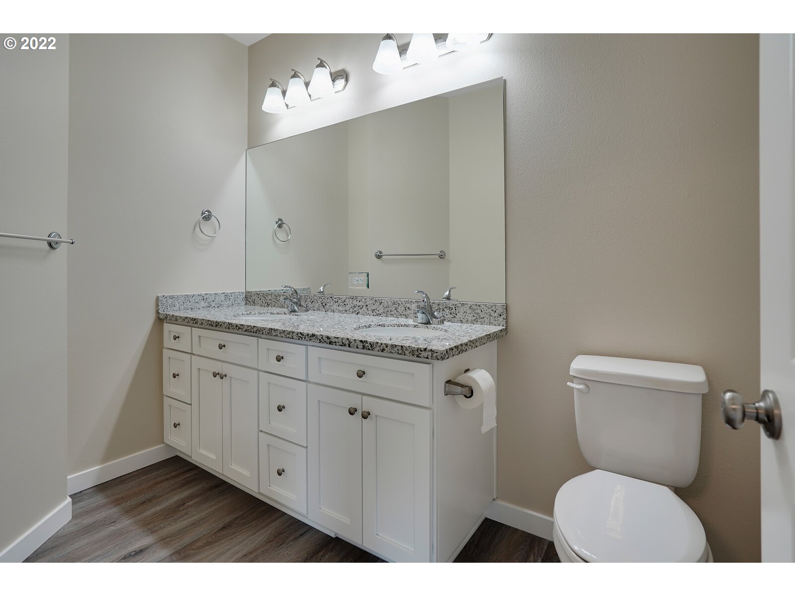 542 East Elm Loop Gervais, OR 97026 - Photo 28 of 32 a bathroom with a granite countertop toilet sink and mirror
