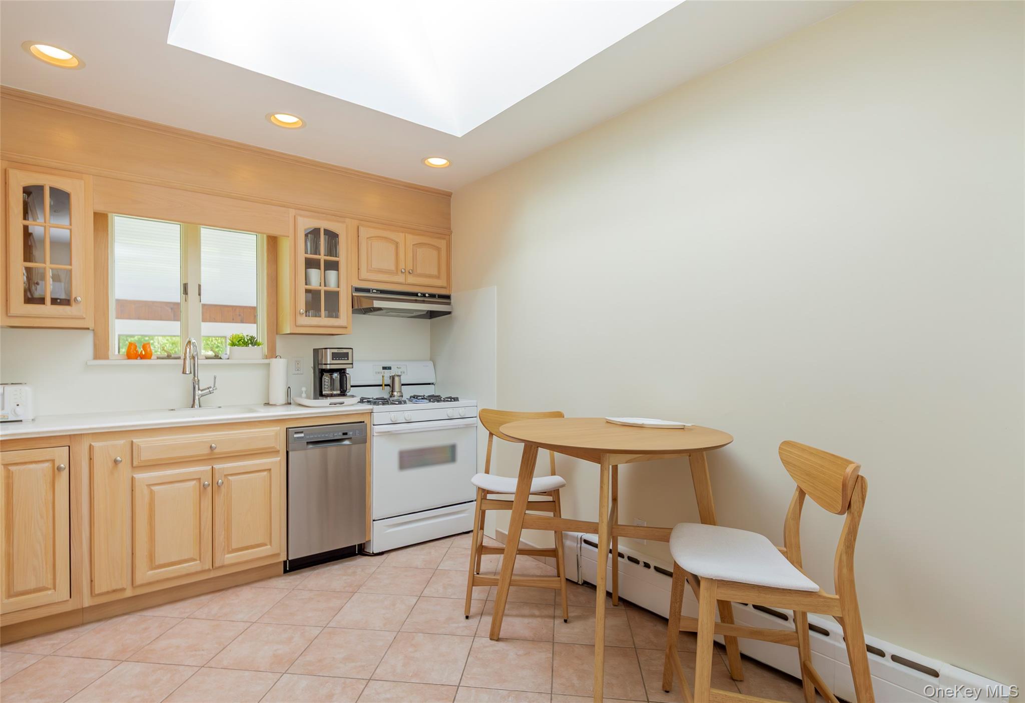 275 Maier Place Southold, NY 11971 - Photo 15 of 27 a kitchen with a sink and chairs