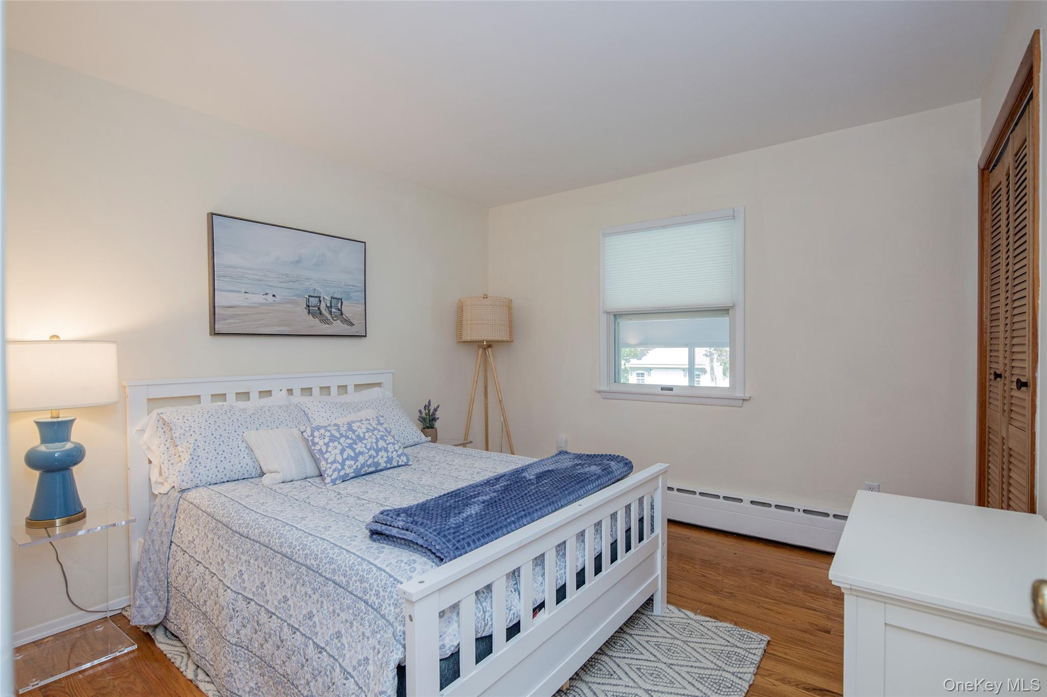 275 Maier Place Southold, NY 11971 - Photo 19 of 27 a bedroom with a bed and a window