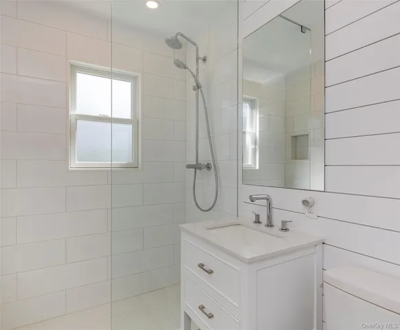 a bathroom with a granite countertop sink a shower and a mirror
