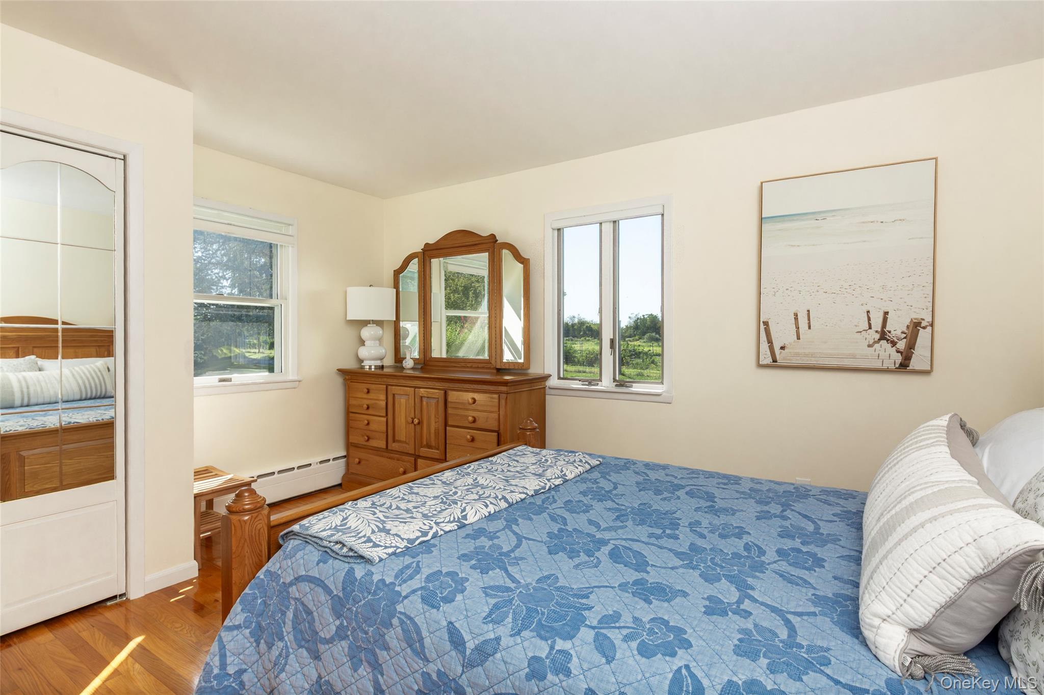 275 Maier Place Southold, NY 11971 - Photo 23 of 27 a bedroom with a large bed and a window