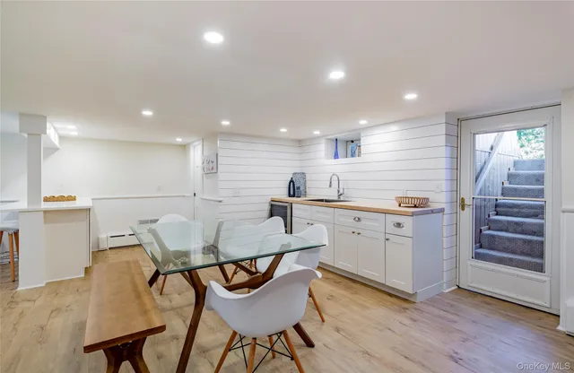 a kitchen with a table chairs sink and cabinets