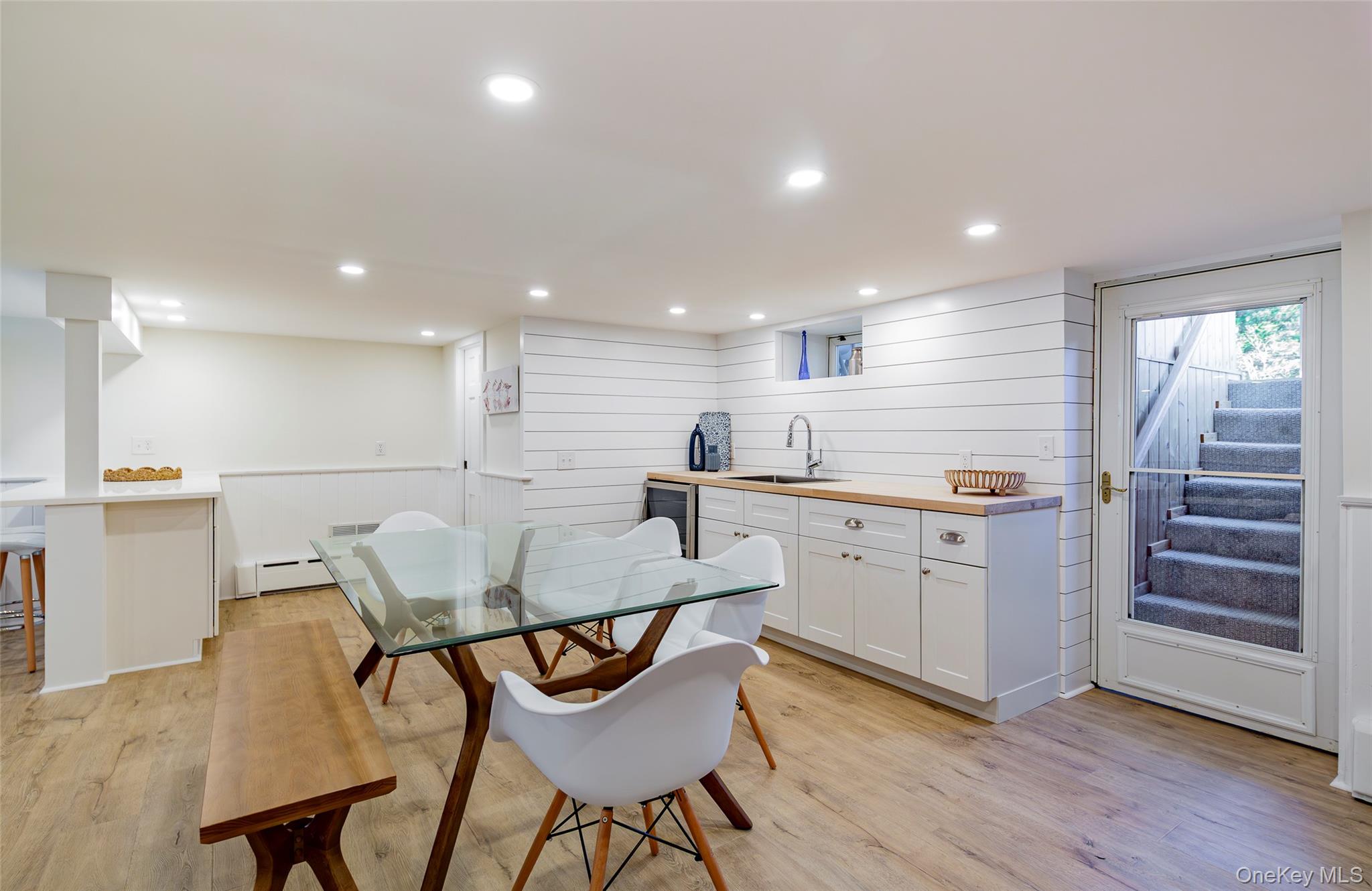 275 Maier Place Southold, NY 11971 - Photo 8 of 27 a kitchen with a table chairs sink and cabinets