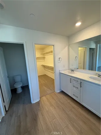 a spacious bathroom with a double vanity sink and a mirror