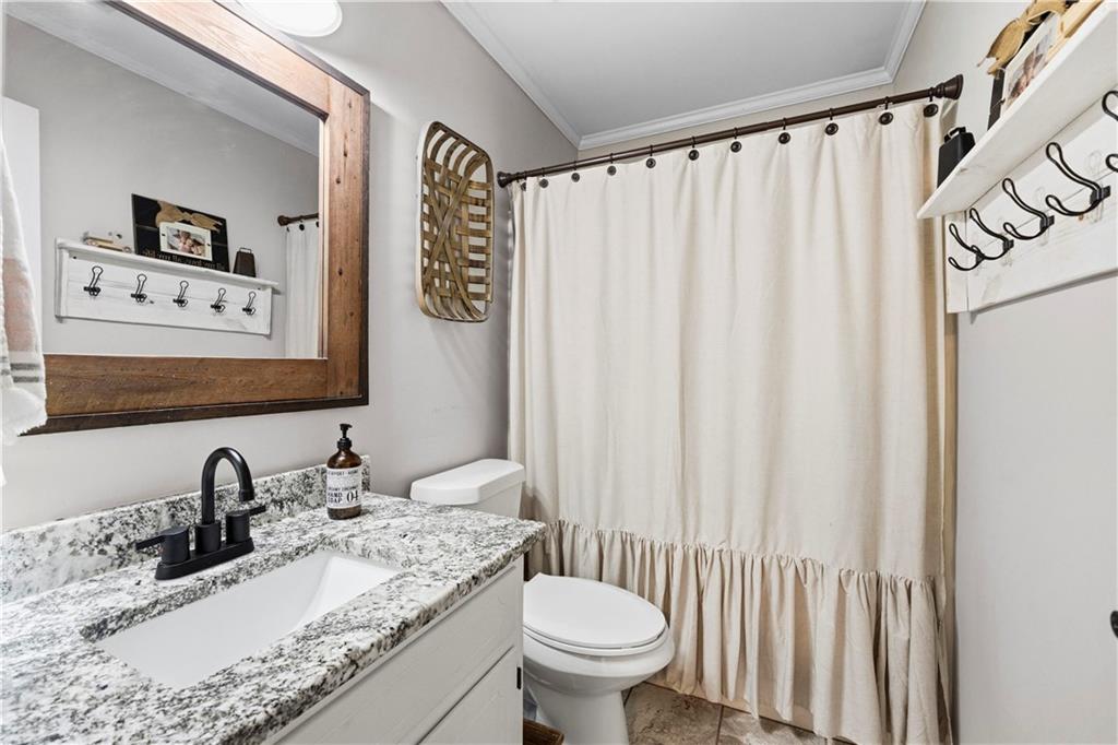 2777 Chickadee Drive Monroe, GA 30655 - Photo 26 of 36 a bathroom with a granite countertop sink and a mirror