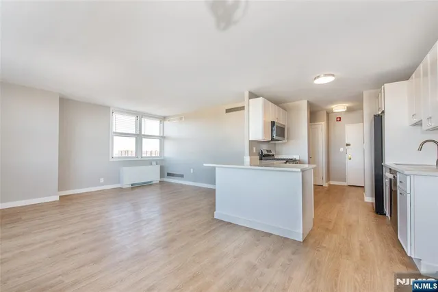 a view of a kitchen and a sink a window