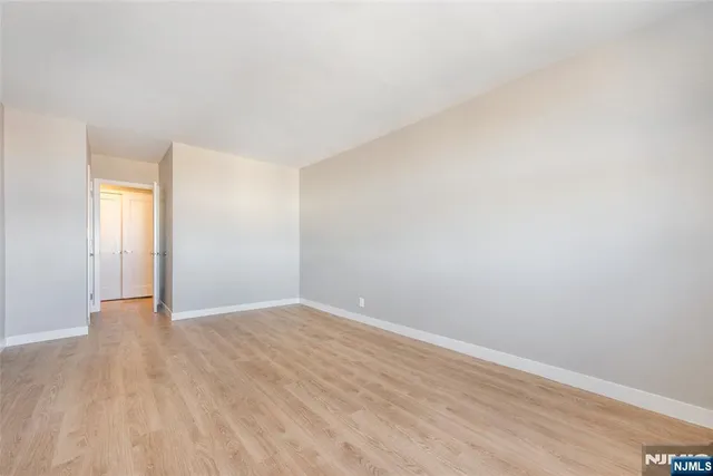 a view of an empty room and wooden floor