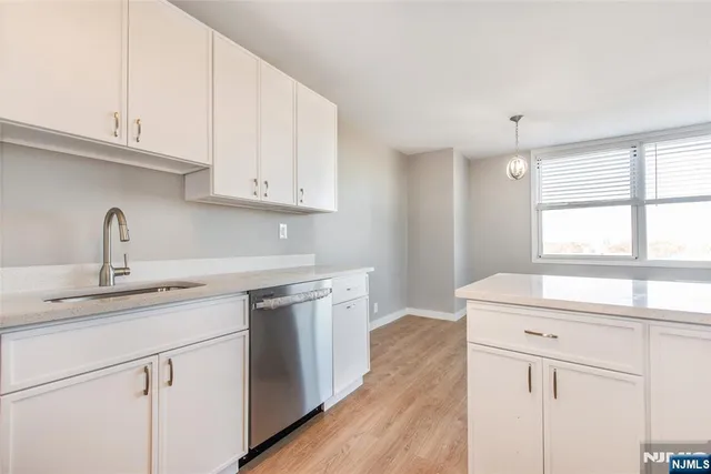 a kitchen with white cabinets and a sink