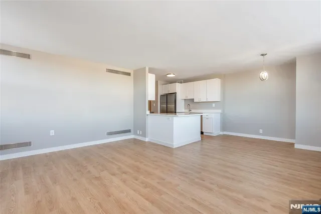 a view of a kitchen with a sink and a refrigerator