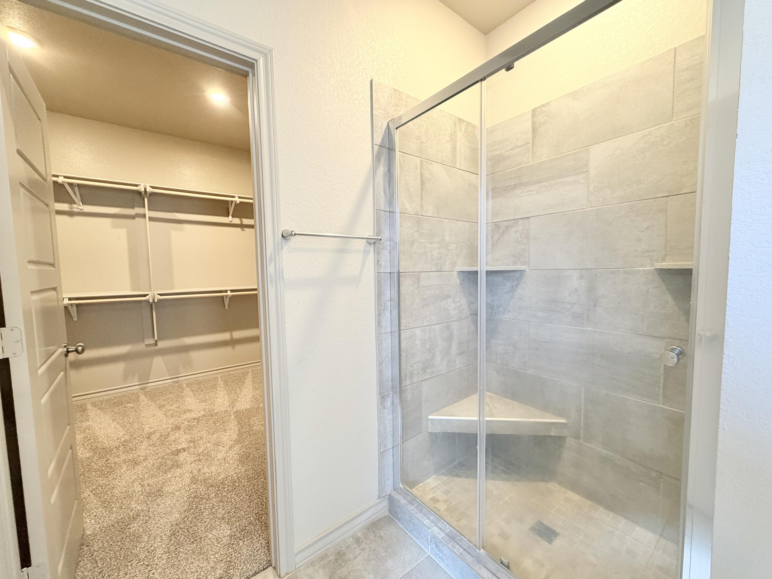 7611 61st Street Lubbock, TX 79407 - Photo 20 of 31 a bathroom with a glass shower door