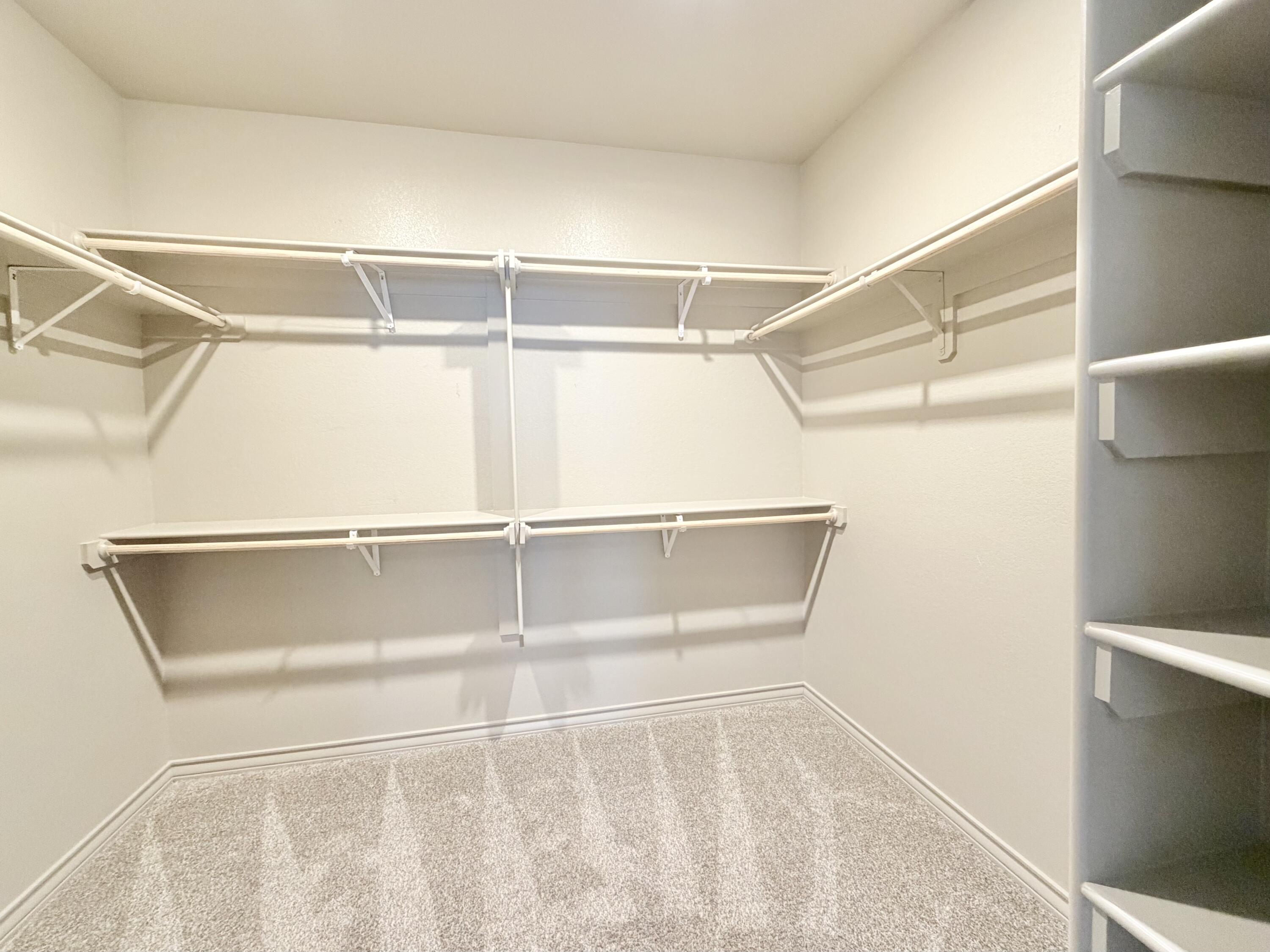 7611 61st Street Lubbock, TX 79407 - Photo 23 of 31 a view of an empty room with racks on the wall