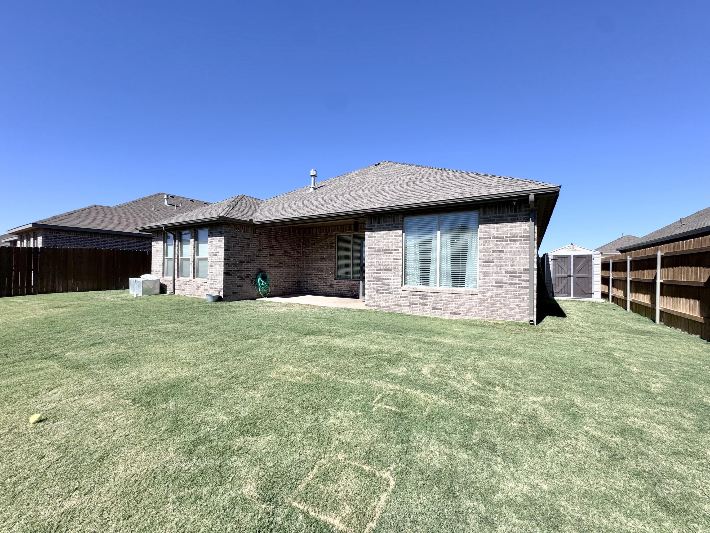 7611 61st Street Lubbock, TX 79407 - Photo 31 of 31 a front view of a house with a garden