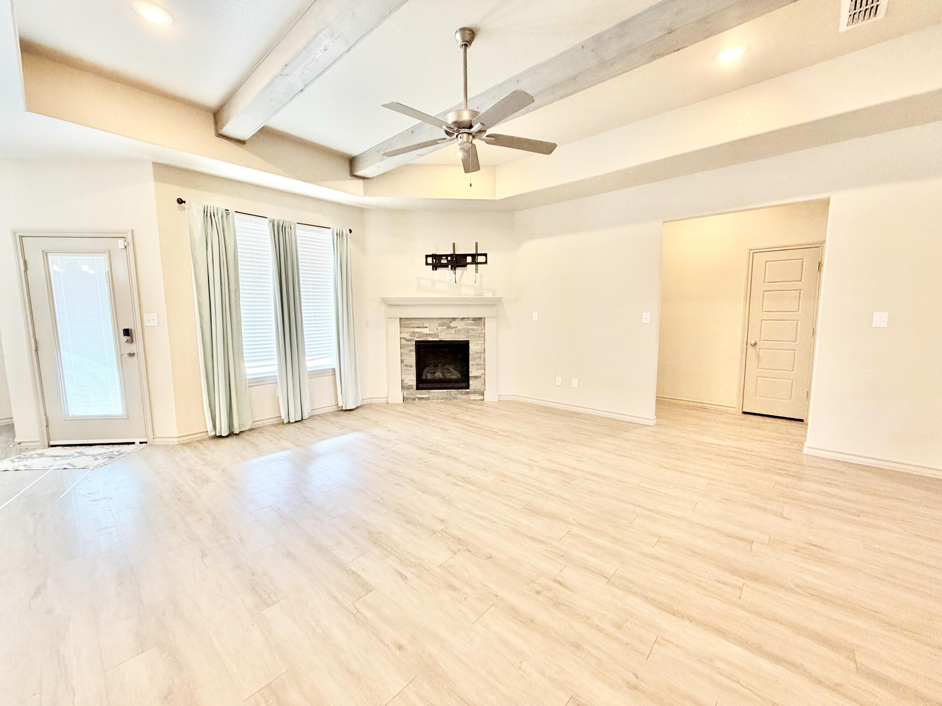 7611 61st Street Lubbock, TX 79407 - Photo 6 of 31 an empty room with fan and windows