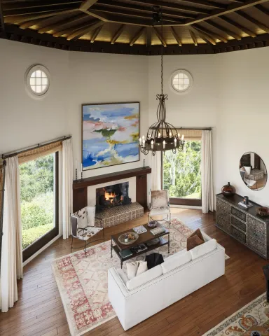 a room with lots of wooden furniture and a fireplace
