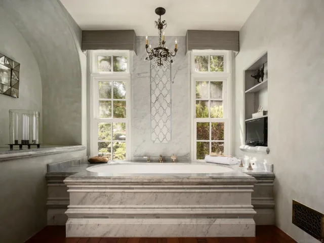 a bedroom with a bed and a chandelier