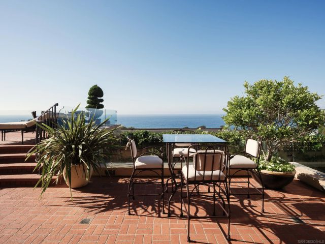 a front view of a multi story building with yard