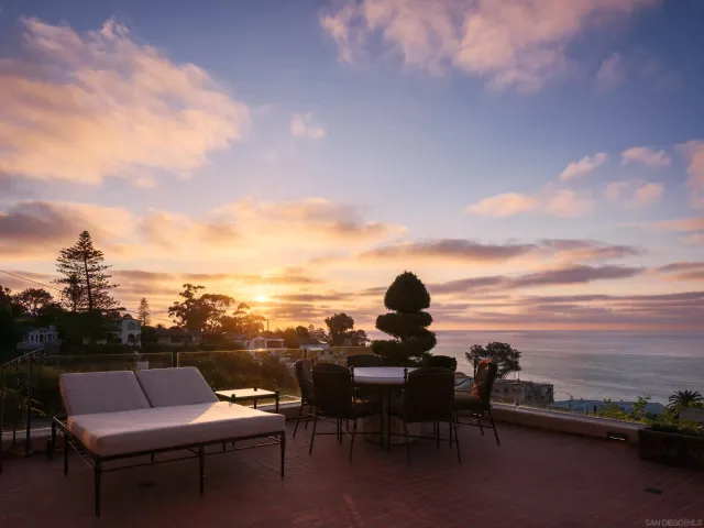a front view of a house with porch and outdoor seating