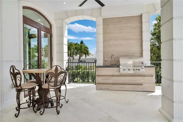 a living room with stainless steel appliances furniture and a chandelier