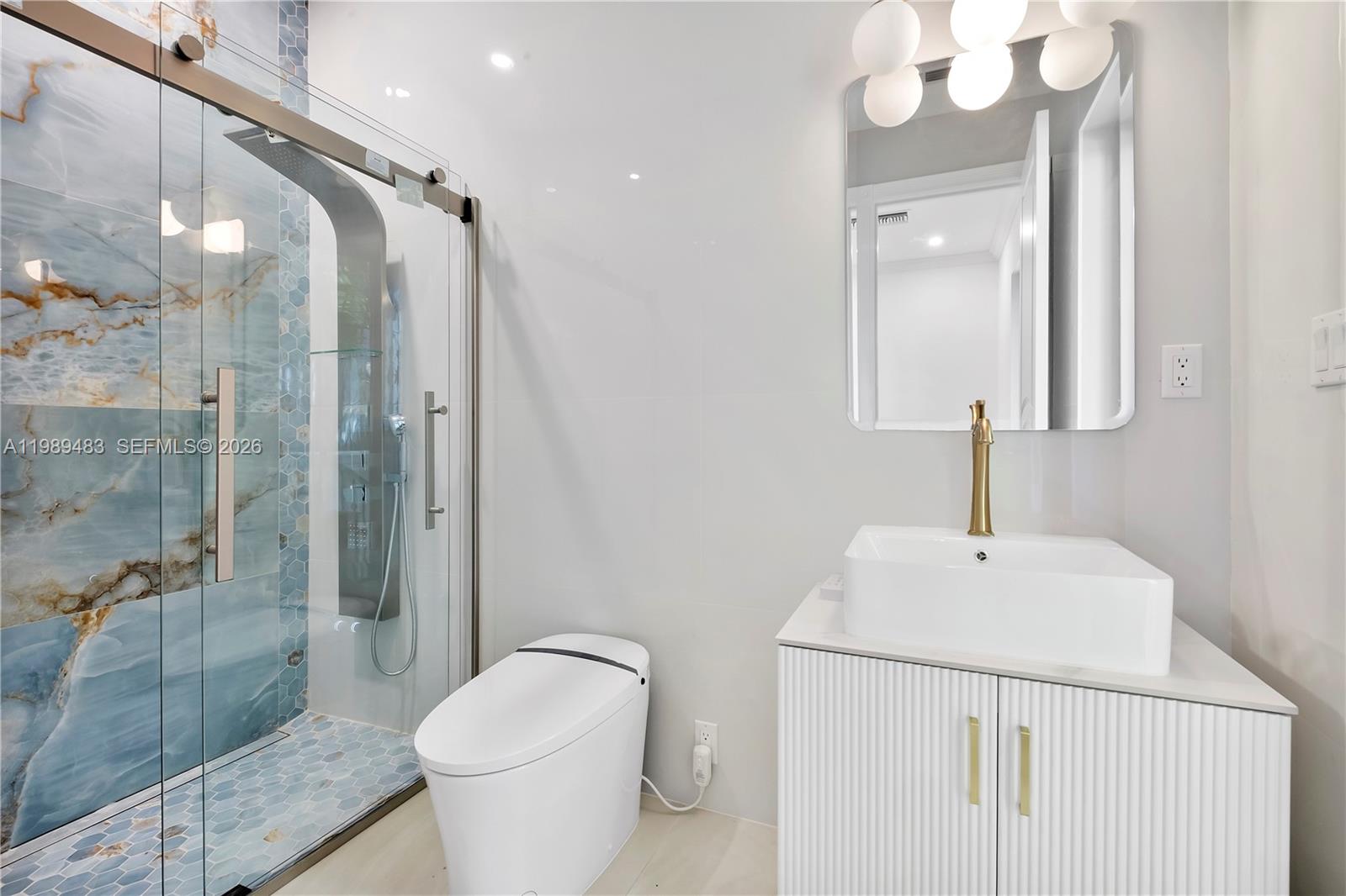 919 92nd Street Surfside, FL 33154 - Photo 29 of 74 a bathroom with a sink a toilet and shower