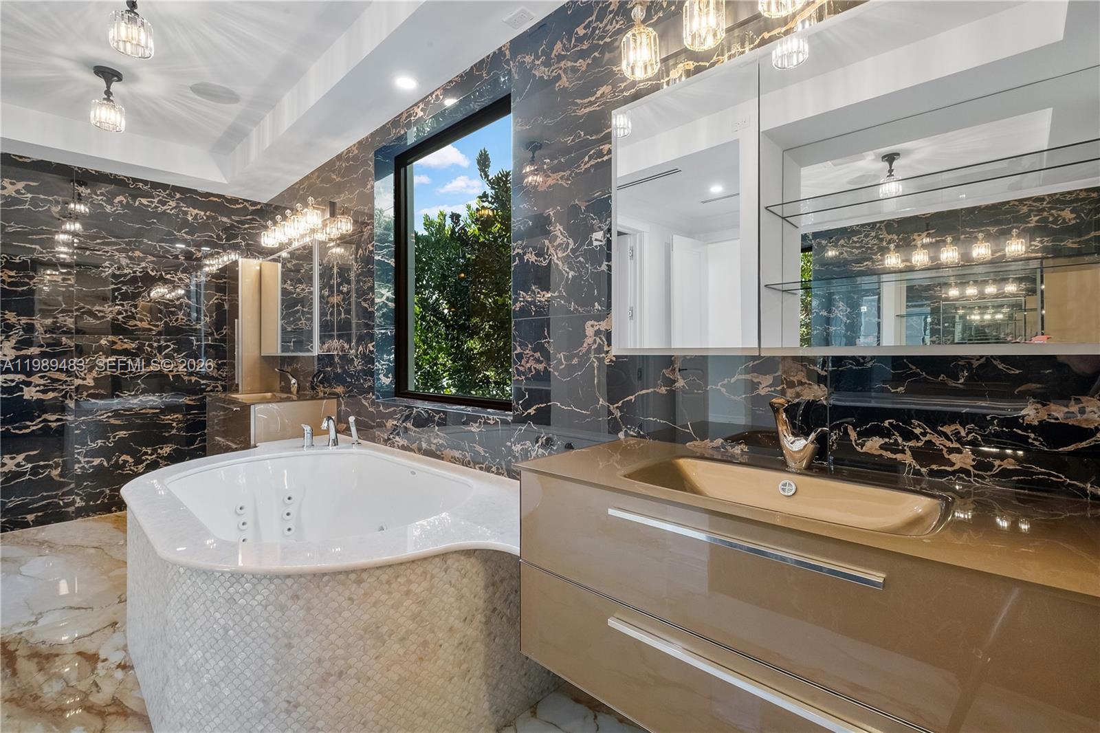 919 92nd Street Surfside, FL 33154 - Photo 35 of 74 a bathroom with a granite countertop sink and a mirror