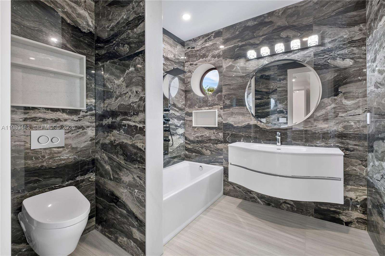 919 92nd Street Surfside, FL 33154 - Photo 50 of 74 a bathroom with a toilet a sink and mirror