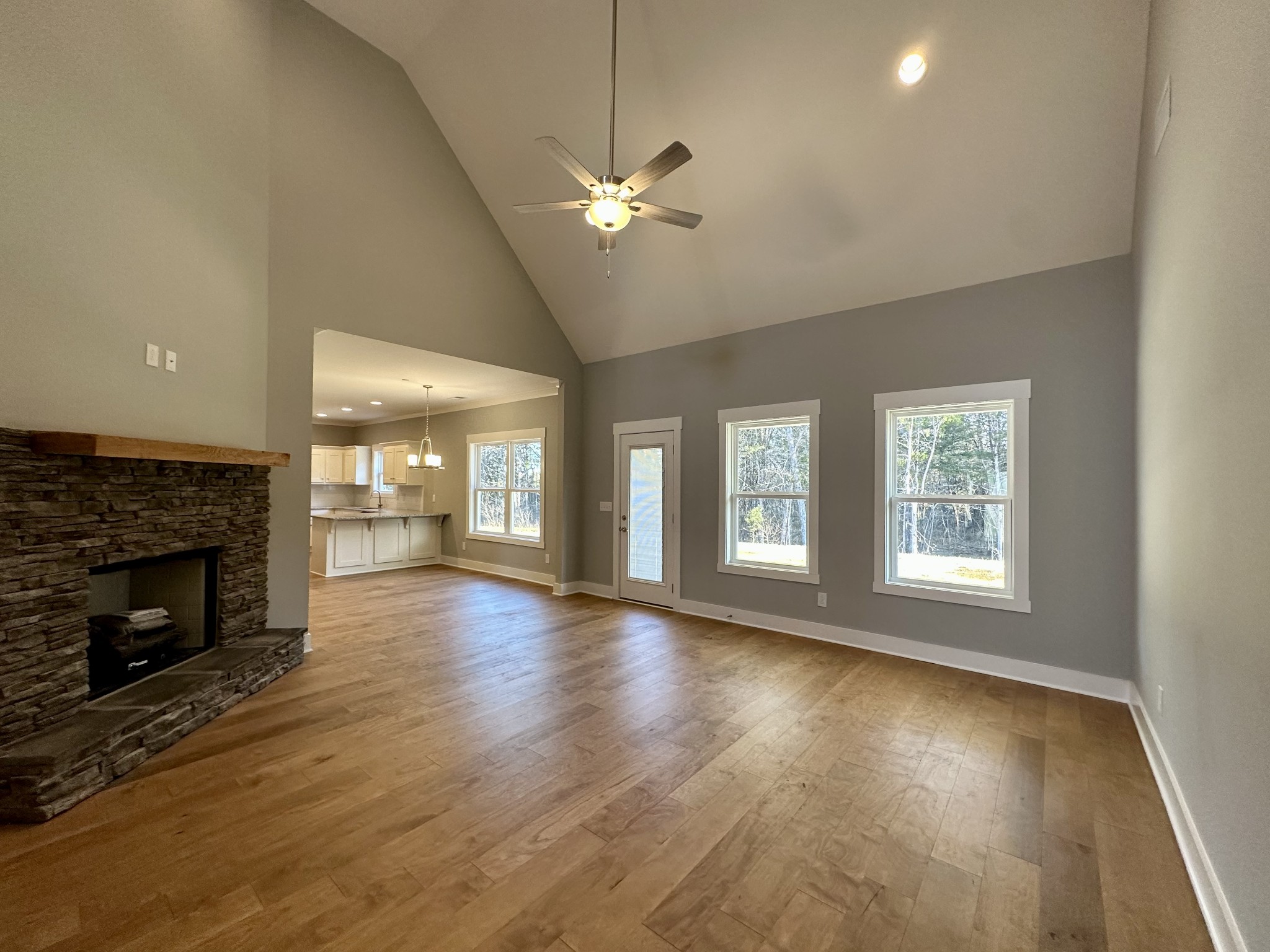 1212 White Rock Road Murfreesboro, TN 37129 - Photo 4 of 30 a view of an empty room with wooden floor fireplace and a window