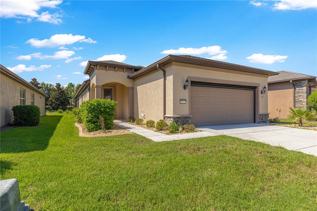 9672 Southwest 63rd Loop Ocala, FL 34481 - Photo 1 of 1 a front view of a house with yard and green space