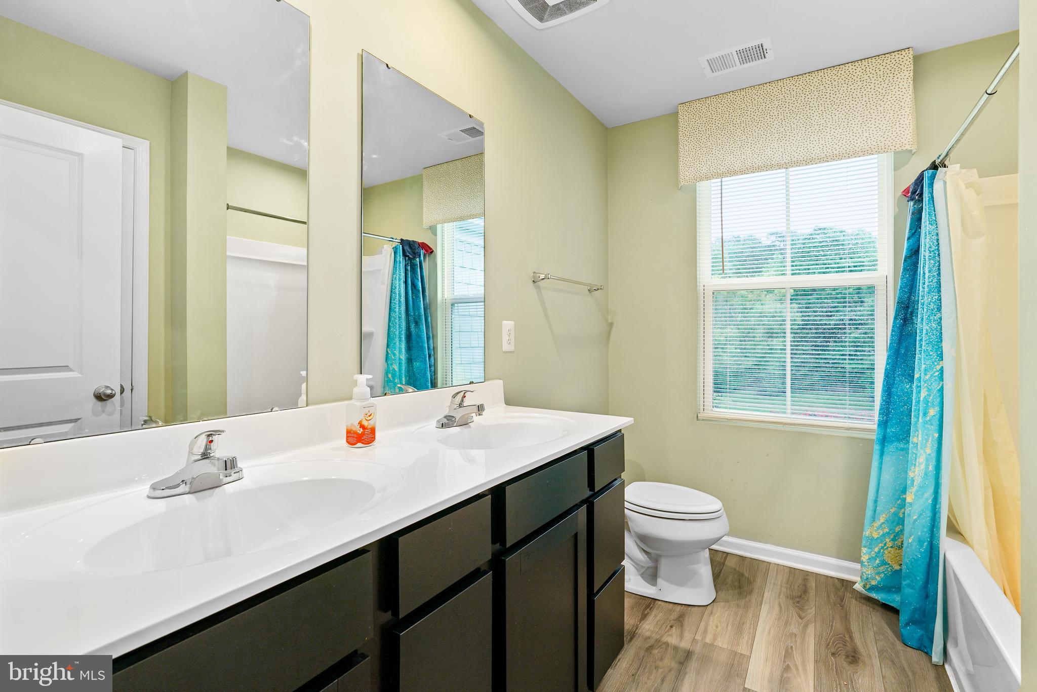 2 Ridgely Forest Drive Elkton, MD 21921 - Photo 31 of 54 a bathroom with a sink a toilet a mirror and a window