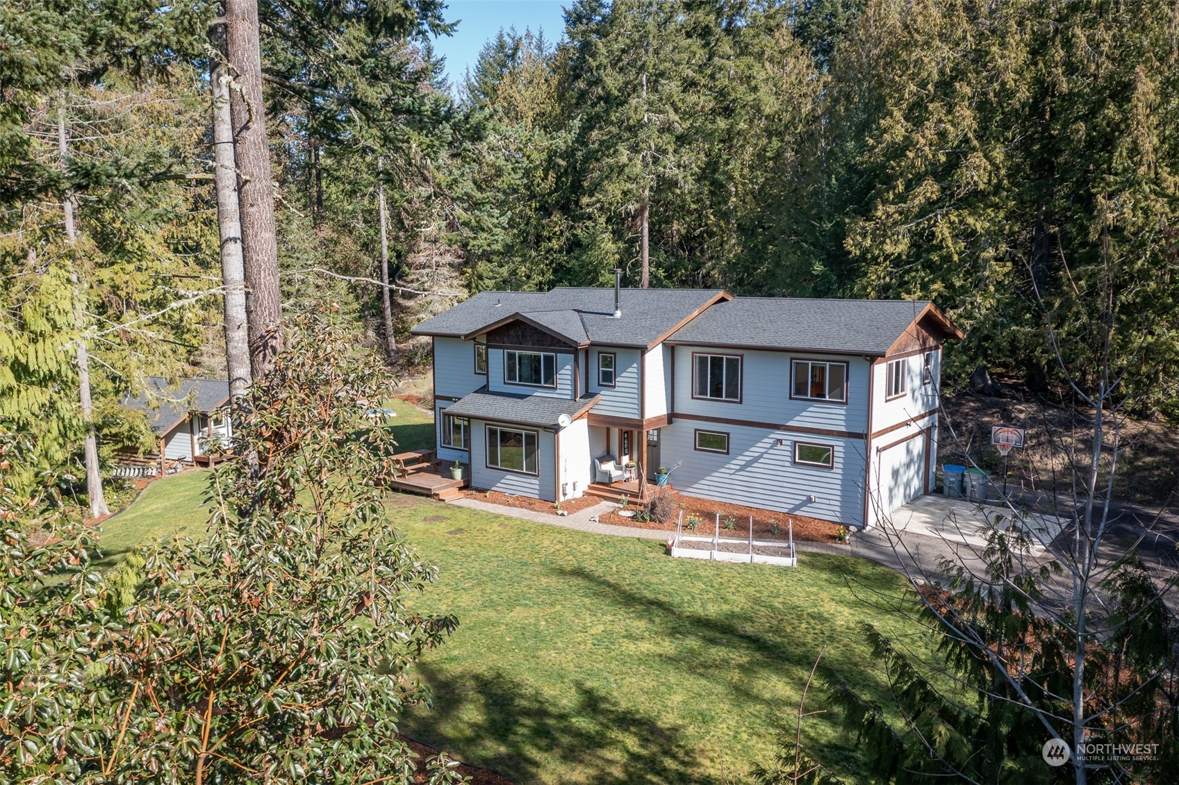 a view of a house with pool and sitting area