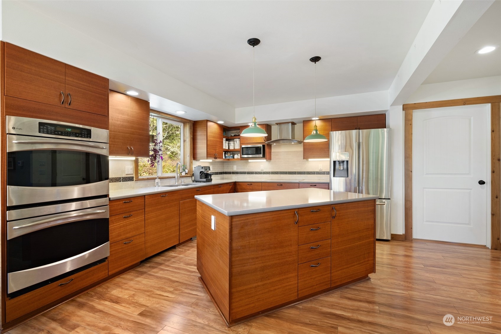 3956 Happy Valley Road Sequim, WA 98382 - Photo 13 of 40 a kitchen with stainless steel appliances granite countertop a stove a sink and a refrigerator