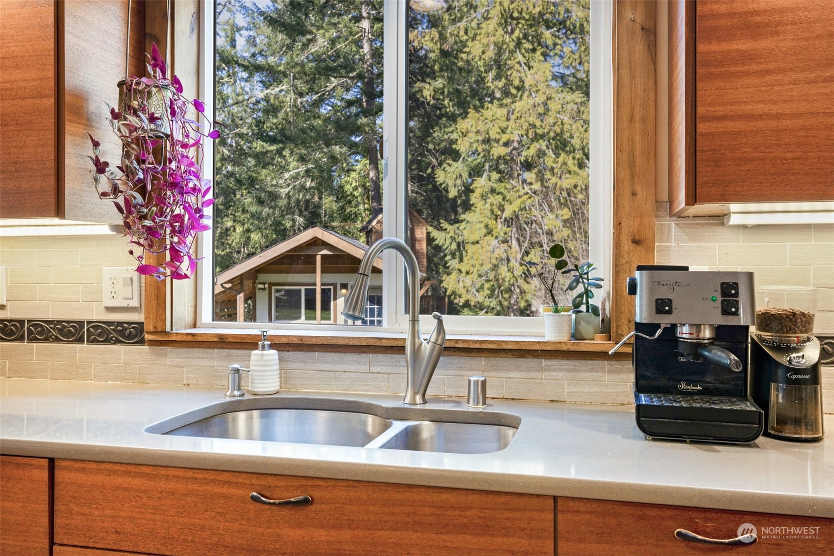 3956 Happy Valley Road Sequim, WA 98382 - Photo 18 of 40 a kitchen sink with granite countertop a sink and a stove next to a window