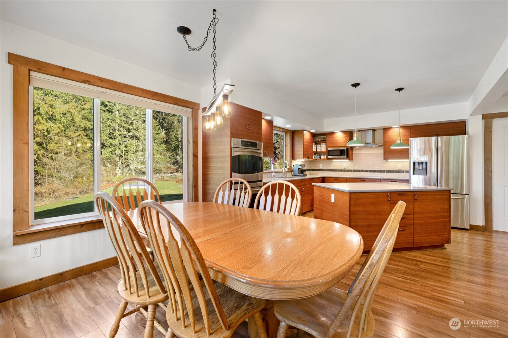 3956 Happy Valley Road Sequim, WA 98382 - Photo 19 of 40 a dining room with furniture a chandelier and wooden floor