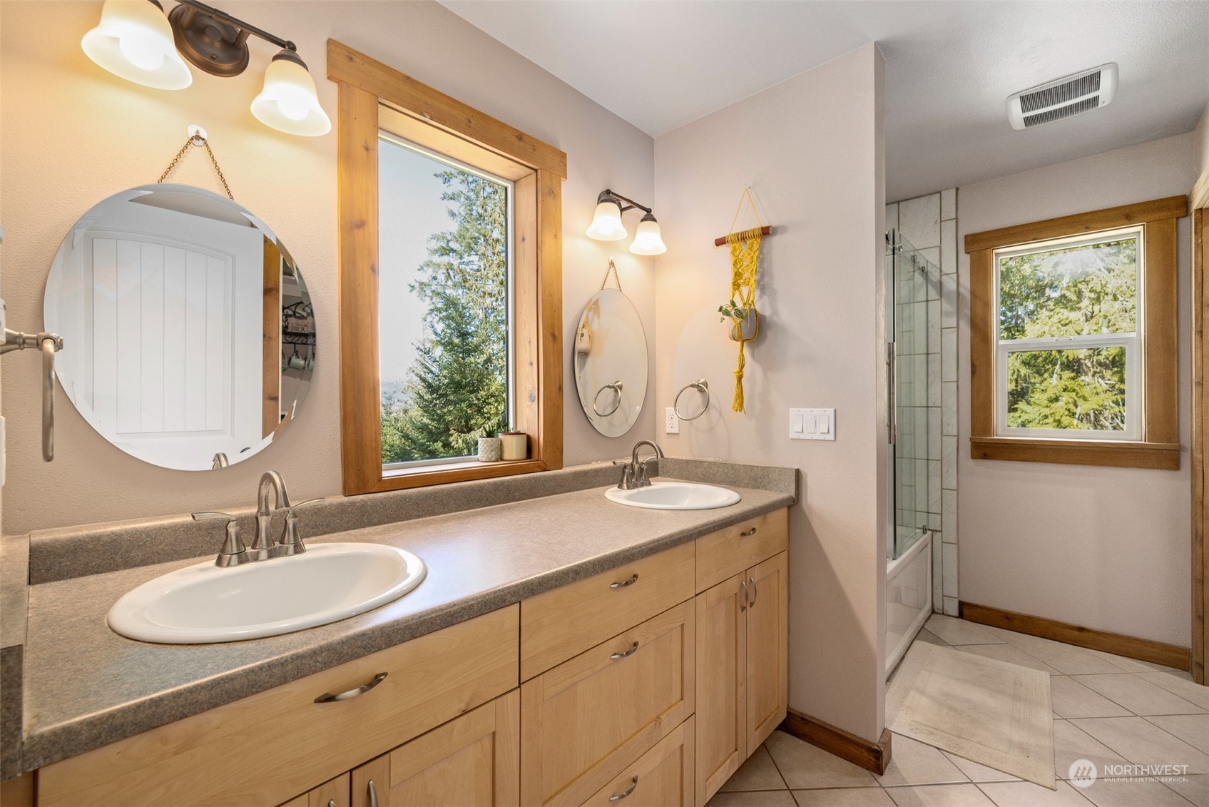 3956 Happy Valley Road Sequim, WA 98382 - Photo 31 of 40 a bathroom with a granite countertop sink a mirror and a shower