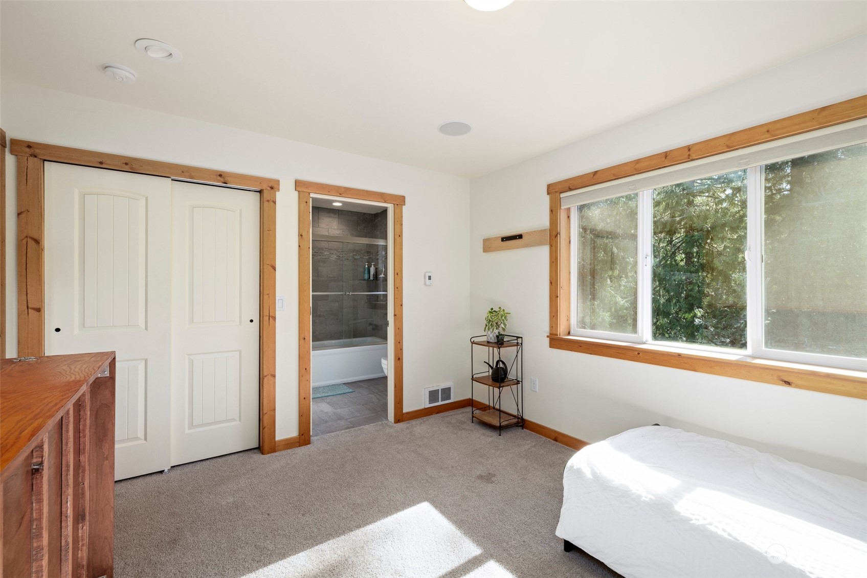 3956 Happy Valley Road Sequim, WA 98382 - Photo 33 of 40 a spacious bedroom with a bed and a large window