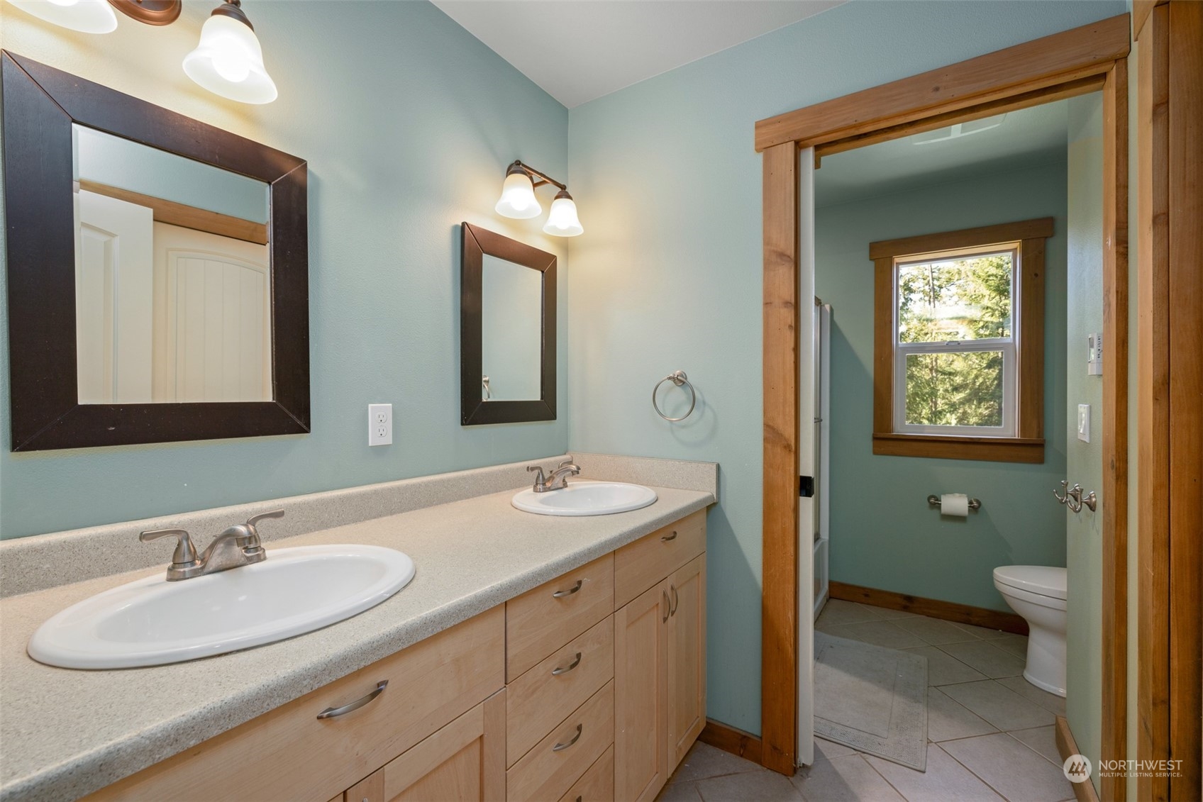 3956 Happy Valley Road Sequim, WA 98382 - Photo 39 of 40 a bathroom with a granite countertop sink toilet and mirror