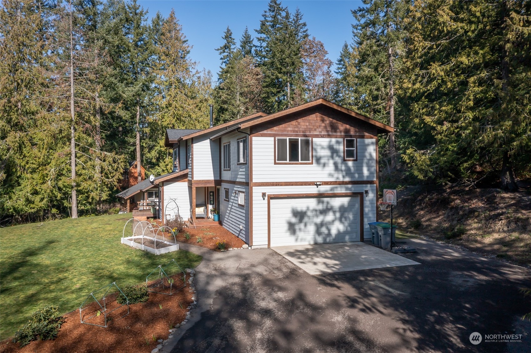 3956 Happy Valley Road Sequim, WA 98382 - Photo 6 of 40 a front view of a house with a yard garage and outdoor seating