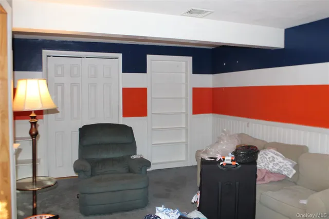 a living room with furniture and a lamp